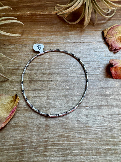Native-made sterling silver bangle bracelets, each unique in pattern and finish, sold separately