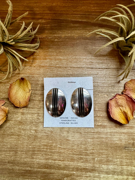 Stamped sterling silver concho stud earrings handmade by Navajo artist Yolanda Yazzie