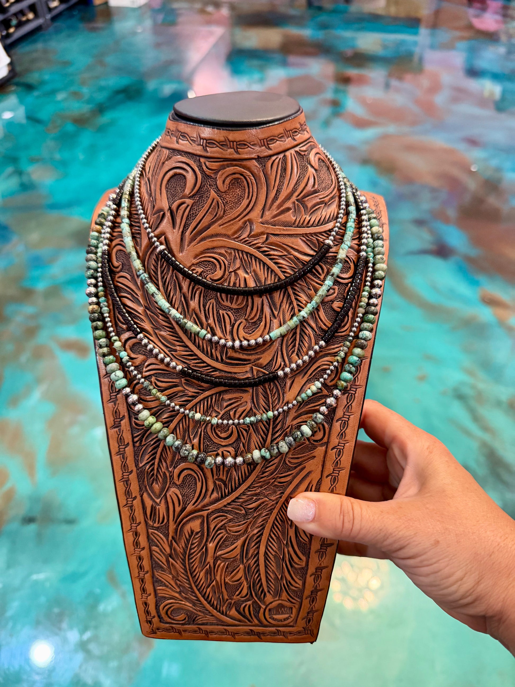 Five-piece layering necklace set featuring African turquoise, black onyx, sterling silver pearls, heishi beads, and rondelles in 14-inch, 16-inch, and 19-inch lengths with extenders. Handmade in the USA by The Bijoux FAB.