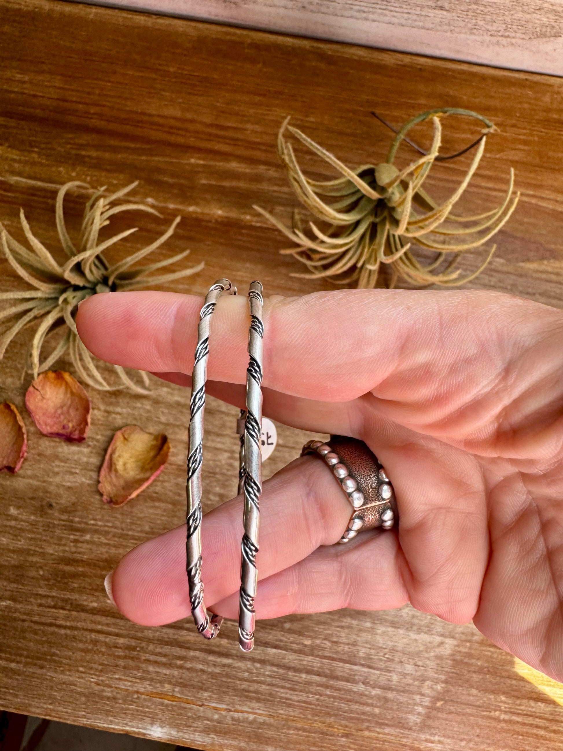 Native-made sterling silver bangle bracelets, each unique in pattern and finish, sold separately
