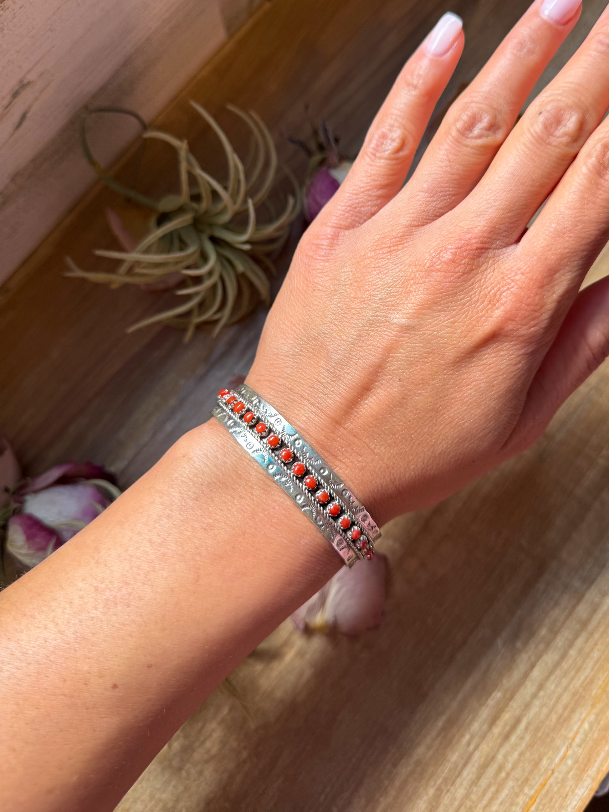 Sterling silver red coral cuff bracelet with artist stamp JPukestine and detailed Southwestern stamp work, made in the USA