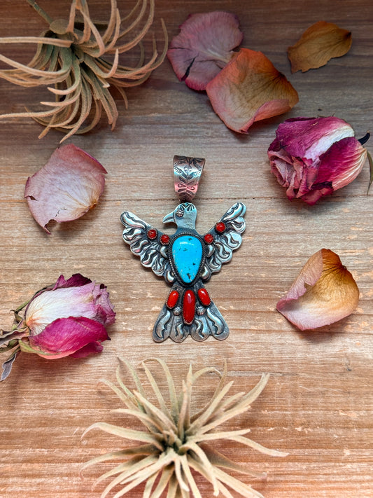 Large sterling-silver Thunderbird pendant with red coral and turquoise stones, stamped Richard Yazzie and Sterling, 4 inches long by 3 inches wide, 16 mm bail, Native made in USA